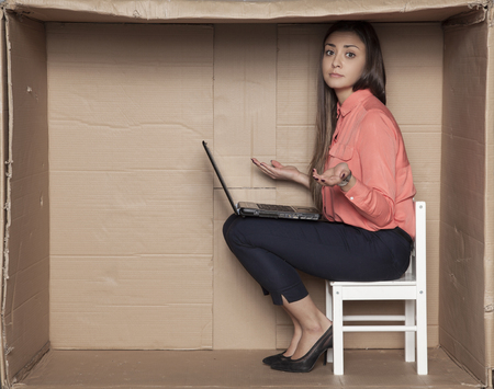 the secretary spreads his hands in helplessness, a broken laptopの写真素材