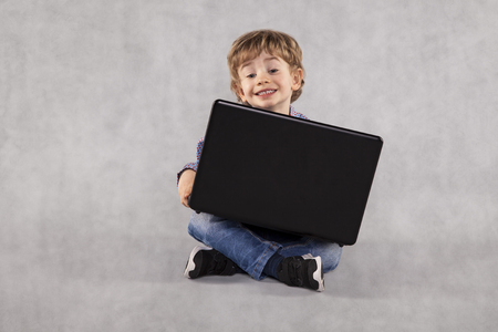 small businessman uses a laptop, learning from an early ageの写真素材