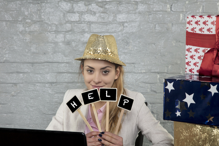 business woman is spending Christmas at work, idea of calling for helpの写真素材