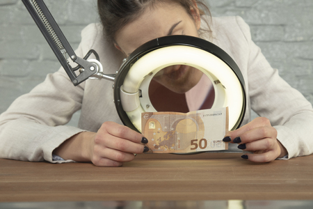 banker checked the money for authenticityの写真素材