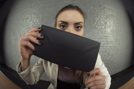 business woman received a black envelope as a giftの写真素材