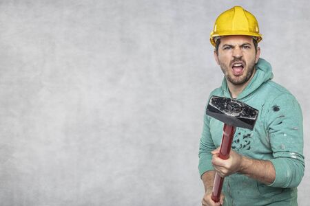 construction worker with a hammer in hand, concept of construction and disassembly, renovationの写真素材