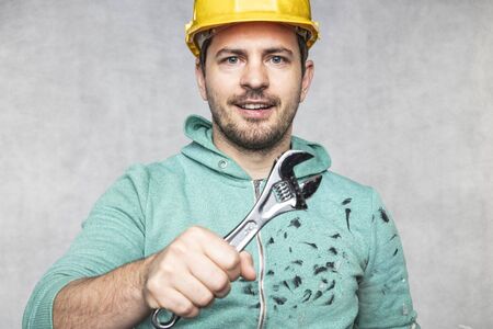the construction worker holds the key in his hands, the key as a source of inspiration and ingenuityの写真素材