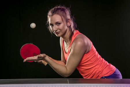 young beautiful athletic girl playing table tennisの写真素材