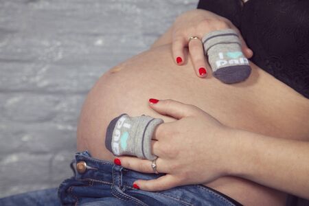 Unrecognizable woman with pregnancy tummy, future motherの写真素材