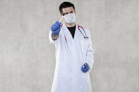 the doctor is holding ampoule for coronavirus testsの写真素材