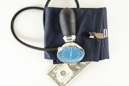  US dollar in a blood pressure monitor, currency treatment concept
