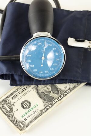 US dollar in a blood pressure monitor, currency treatment conceptの写真素材