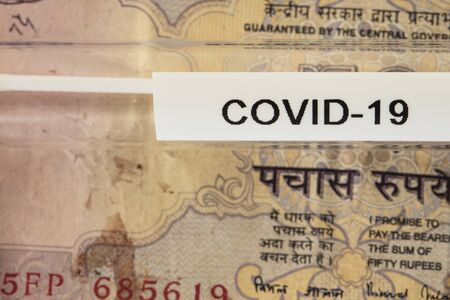 concept of crisis in India caused by virus, test on banknoteの写真素材