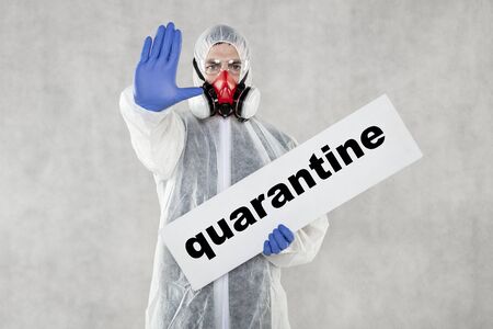 virologist in protective clothing holds advertising space in his handsの写真素材