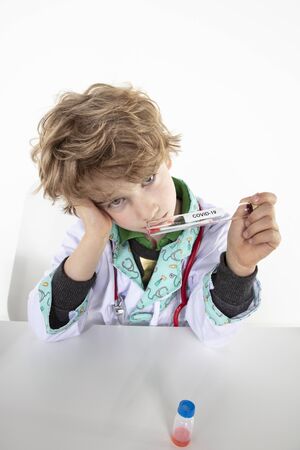 depressed doctor looking at swab sample, coronavirus testsの写真素材