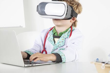 young doctor in virtual reality goggles is working on a 3D model of the virusの写真素材