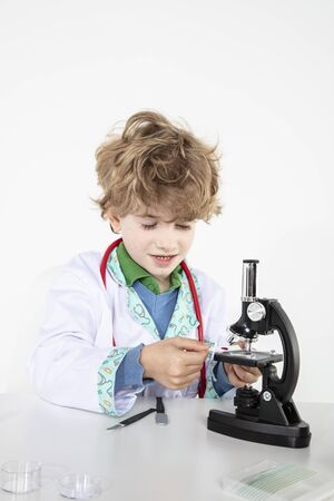 young doctor sitting over a microscope in his laboratoryの写真素材