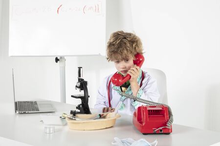 young doctor screams into headphones during a telephone conversationの写真素材