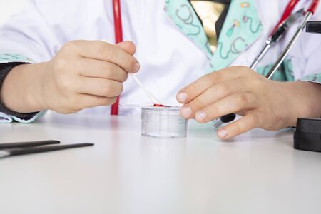  young doctor puts a blood sample on a glass slide

の写真素材