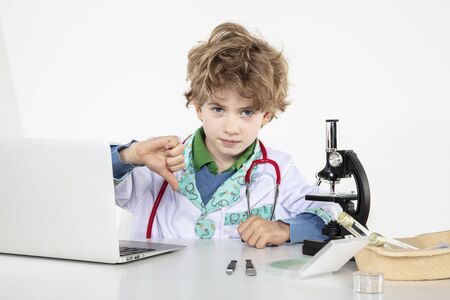 young doctor sitting over a microscope in his laboratoryの写真素材