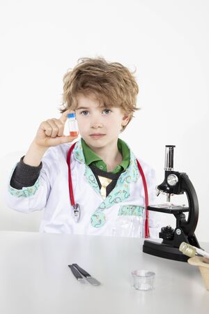 young doctor looks at the finished vaccine in the bottleの写真素材