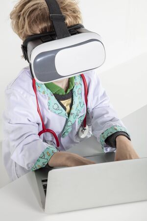 young doctor in virtual reality goggles is working on a 3D model of the virusの写真素材