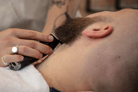 barber cares for his client's beardの写真素材