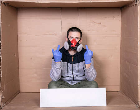 man in a protective mask shows the middle fingerの写真素材