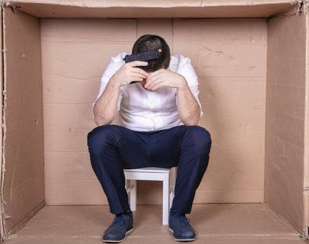 businessman overcrowded depression thoughts of suicide, gun in handの写真素材