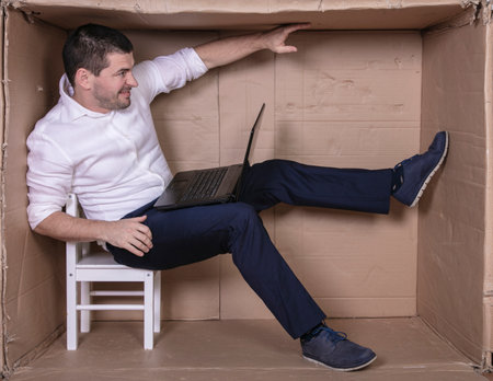 broken businessman in a cardboard office, stress and depression from overworkの写真素材