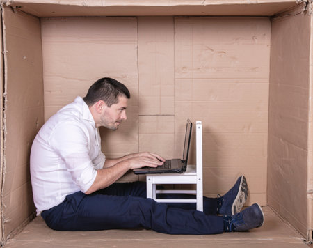 broken businessman in a cardboard office, stress and depression from overworkの写真素材