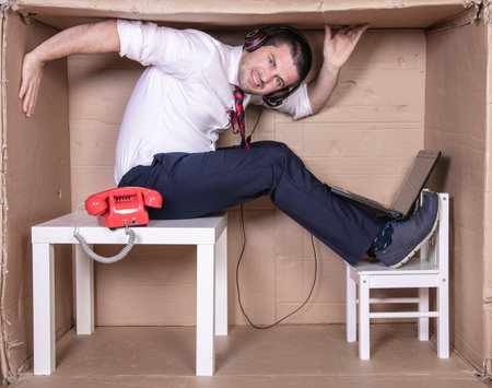 broken businessman in a cardboard office, stress and depression from overworkの写真素材