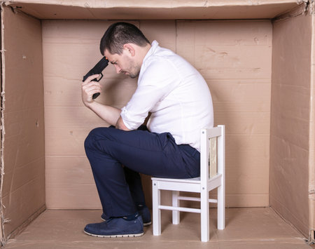 businessman overcrowded depression thoughts of suicide, gun in handの写真素材