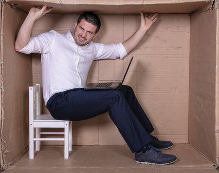 broken businessman in a cardboard office, stress and depression from overworkの写真素材