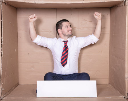 businessman raises his hands up in a gesture of success, copie space on the boardの写真素材