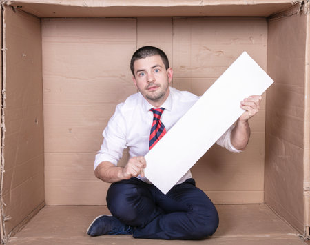 businessman in a cramped office with copy space in his handsの写真素材