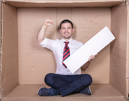 businessman raises his hand clenched into a fist, copy space in the other handの写真素材