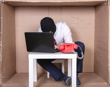 focused employee fights against virus programs, a small tight office in a corporation,の写真素材