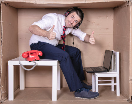 thumbs up from a satisfied office workerの写真素材