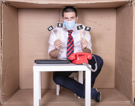 helpless businessman calls for help, placard with the words, copy spaceの写真素材