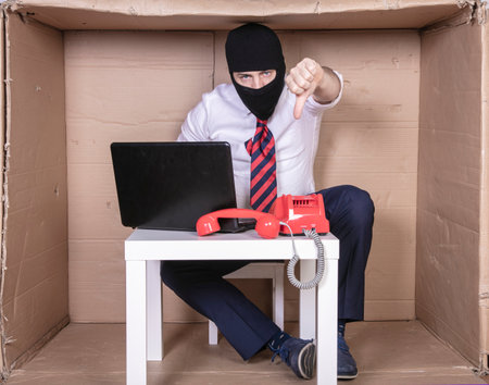 Secret employee fights cybercriminals, shows thumbs downの写真素材