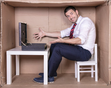 smiling businessman showing empty briefcase, beautiful presentationの写真素材