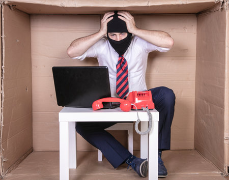 An undercover cop fighting with cybercrime grab his headの写真素材