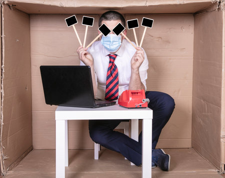 desperate businessman holding blank squares in front of his face, copy spaceの写真素材