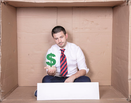 poor businessman dreams of investing in US dollarsの写真素材