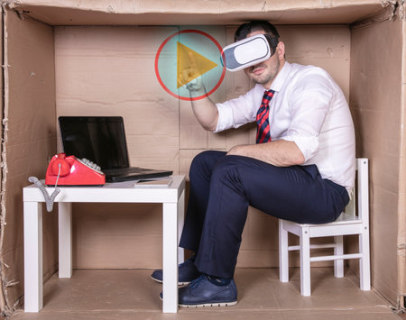 businessman in virtual reality glasses presses the virtual play buttonの写真素材