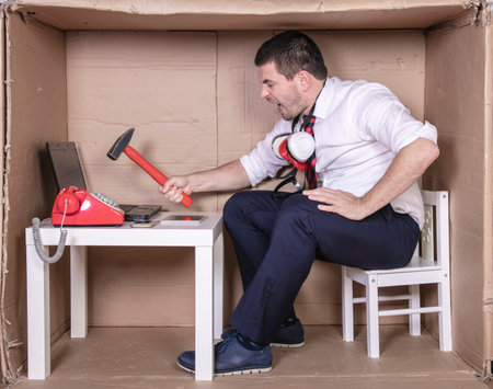 businessman makes an attempt to destroy a computerの写真素材