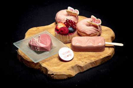 set of tasty sweets lies on a wooden board, side viewの写真素材