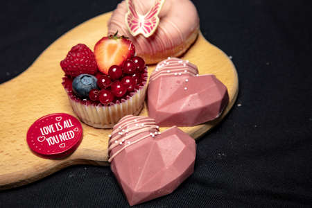 set of sweets lies on a wooden boardの写真素材