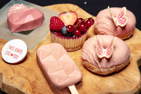 set of tasty sweets lies on a wooden boardの写真素材