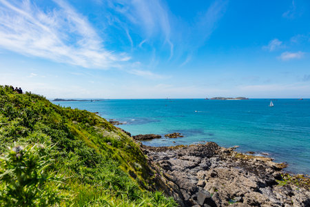 beautiful view from the island towards the sea, small islets and a green slope, Saint Malo, Franceの写真素材