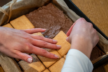 Close-up of a woman's hands taking cookies from a boxの写真素材