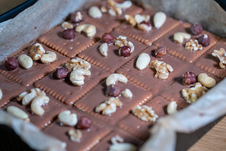 Chocolate bar with nuts on a wooden tableの写真素材