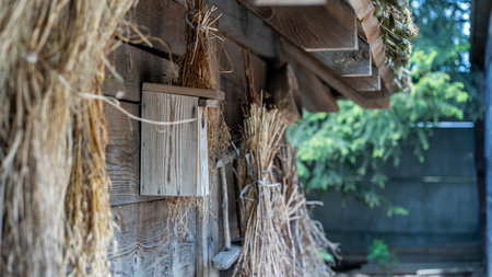 Old wooden house with straw in the countryside, close-up.の写真素材